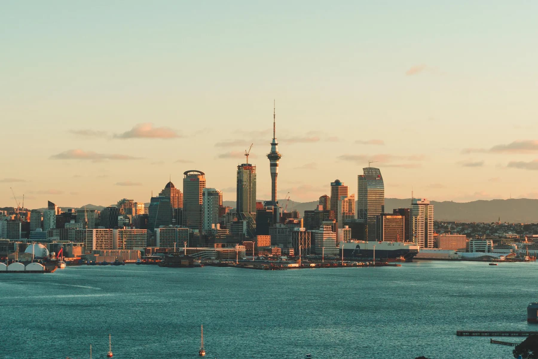 The Auckland skyline across the harbour at sunset